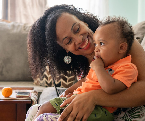 Mother and child sitting on couch in living room